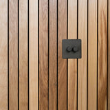 Bronze 2G two way dimmer switch fixed to wooden slatted wall 